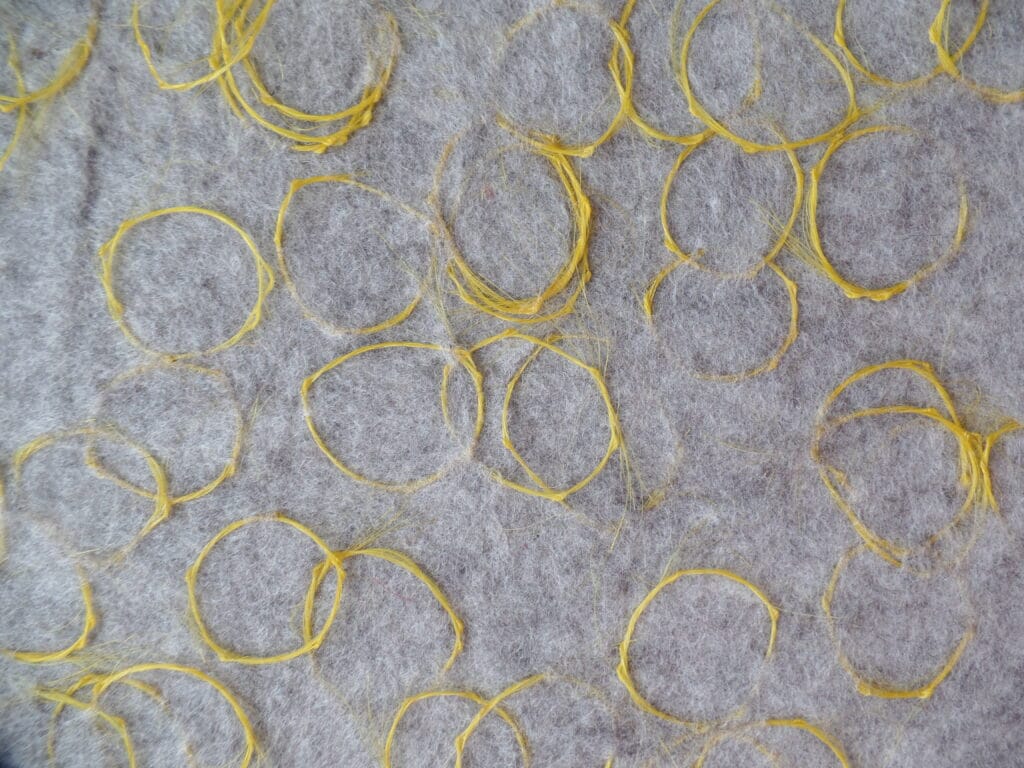 detail yellow horsehair in grey felt