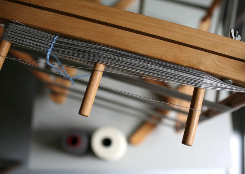 grey threads on wood frame