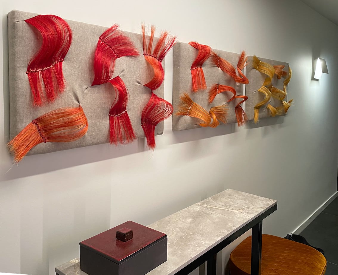 three art panels red orange yellow hallway